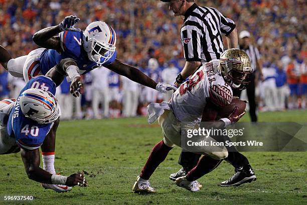 Florida State Seminoles wide receiver Kermit Whitfield is brought down at the 1 yard line by Florida Gators linebacker Jarrad Davis and Florida...