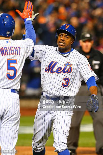 New York Mets right fielder Curtis Granderson high fives New York Mets third baseman David Wright after he rounds the bases after hitting a two run...