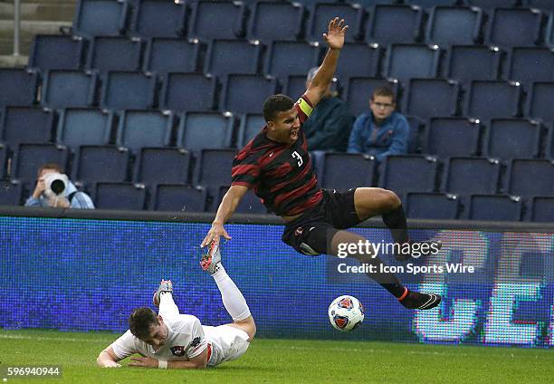 Clemson Aaron Jones sends Stanford Brandon Vincent flying after a sliding tackle during the final of the 2015 men's College Cup at Children's Mercy...