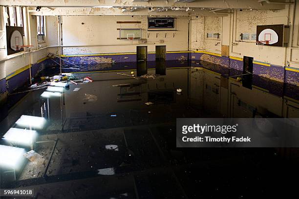 Abandoned High School gymnasium. The decades-long decline of the U.S. Automobile industry is acutely reflected in the urban decay of Detroit, the...
