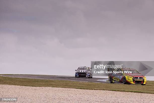Tim Slade of Supercheap Auto Racing and Andre Heimgartner of Super Black Racing during practice for the V8 Supercars WD-40 Philip Island Supersprint...