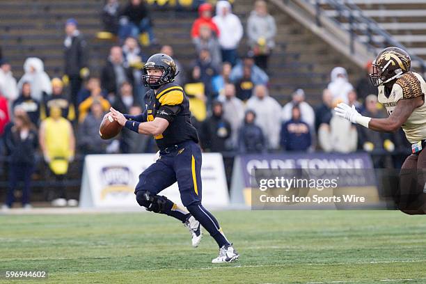 Toledo Rockets quarterback Phillip Ely scrambles with the ball during first half game action between the Western Michigan Broncos and the Toledo...