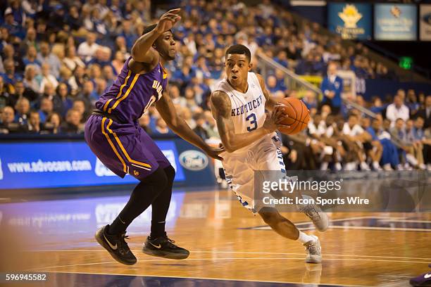Wildcats sophomore guard Tyler Ulis dribbles the ball past Albany senior guard Evan Singletary during the 1st half of the NCAA basketball game...