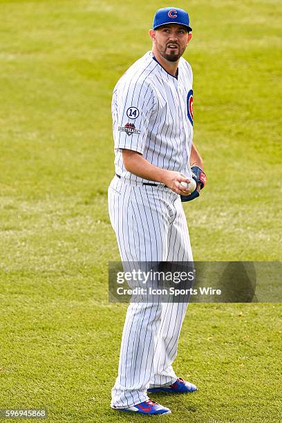 Chicago Cubs starting pitcher Jason Hammel looks into the stands while playing long toss prior to pitching in game 4, of the NLDS, in a game between...