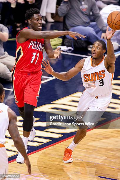 New Orleans Pelicans guard Jrue Holiday shoots against Phoenix Suns guard Brandon Knight during the game between the Phoenix Suns and New Orleans...