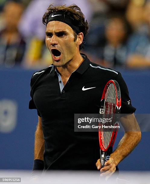 Roger Federer of Switzerland celebrates winning a game in the fourth set against Gael Monfils of France during their match at the US Open in New...