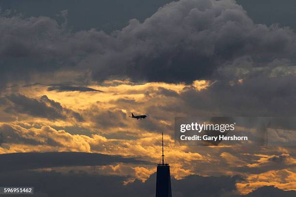 The sun sets over One World Trade Center in Lower Manhattan as seen from the Arthur Ashe tennis stadium in New York, September 8, 2014.