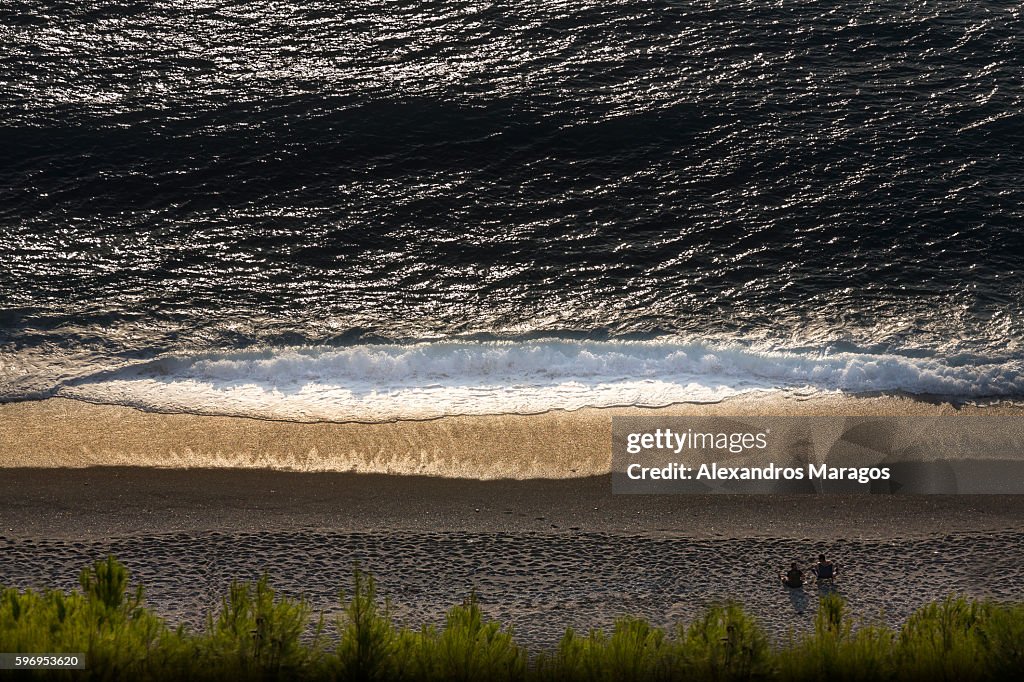 Ocean wave breaking on a beach in Greece