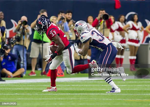 Houston Texans running back Akeem Hunt and New England Patriots cornerback Leonard Johnson during the NFL game between the New England Patriots and...
