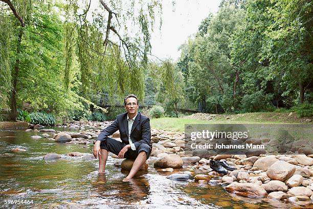 businessman soaking feet in stream - portrait mann business bildbanksfoton och bilder