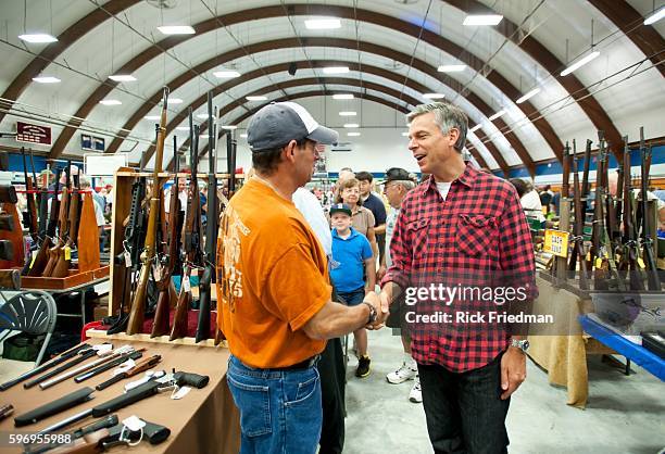 Republican presidential candidate and former Utah Governor Jon Huntsman campaigning with his wife Mary Kaye Huntsman at a gun show in Concord, NH on...