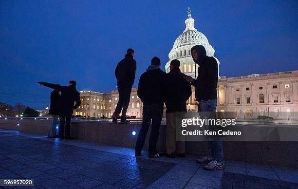 Visitors at the U.S Capitol January 1, 2013 as U.S. Lawmakers work hard toward a midnight deadline averting hundreds of billions of dollars in tax...