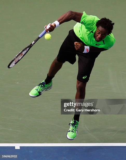 Gael Monfils of France serves to Grigor Dimitrov of Bulgaria in their match at the US Open tennis championship in New York, September 2, 2014.