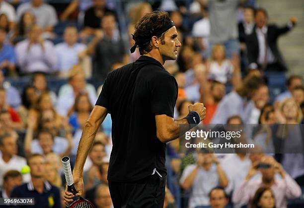 Roger Federer of Switzerland celebrates winning the fourth set against Gael Monfils of France during their match at the US Open in New York,...