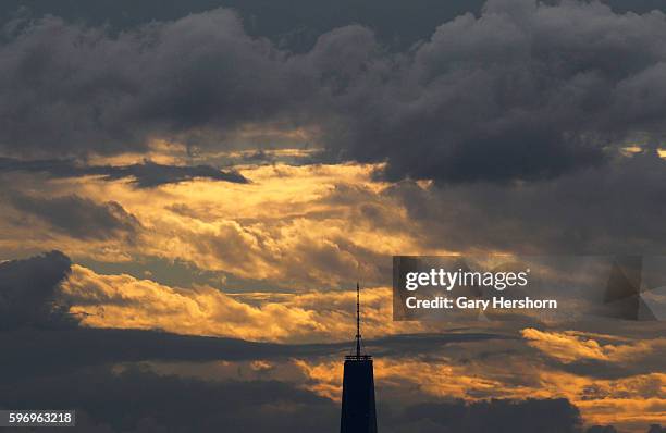 The sun sets over One World Trade Center in Lower Manhattan as seen from the Arthur Ashe tennis stadium in New York