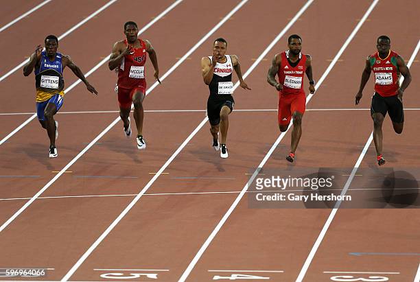 Andre De Grasse of Canada runs to the finish line ahead of Ramon Gittens of the Barbados, Remontay McClain of the USA, Keston Bledman of Trinidad and...