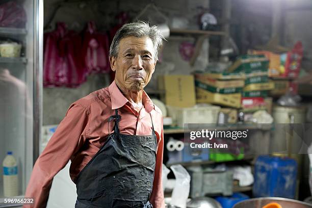 an old senior asian man looking front with confidence and smile - portraits studio smile stockfoto's en -beelden