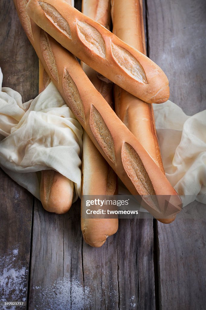 French loaf bread on wooden background.
