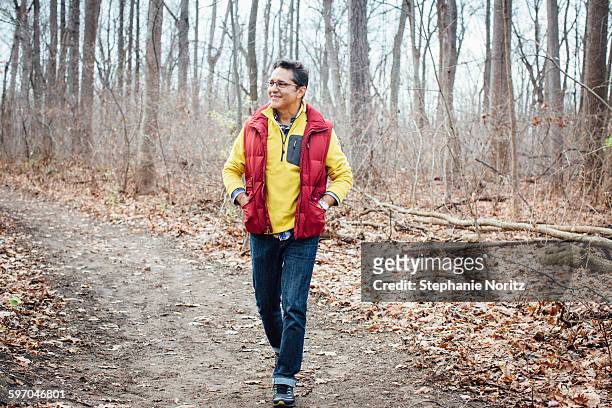 man walking on path through forest smiling - toledo ohio fotografías e imágenes de stock