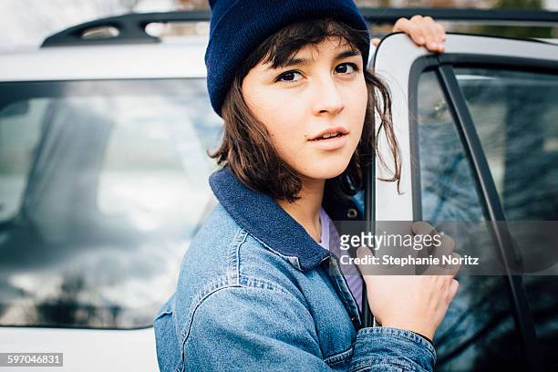 Portrait of Young Woman Opening Car Door