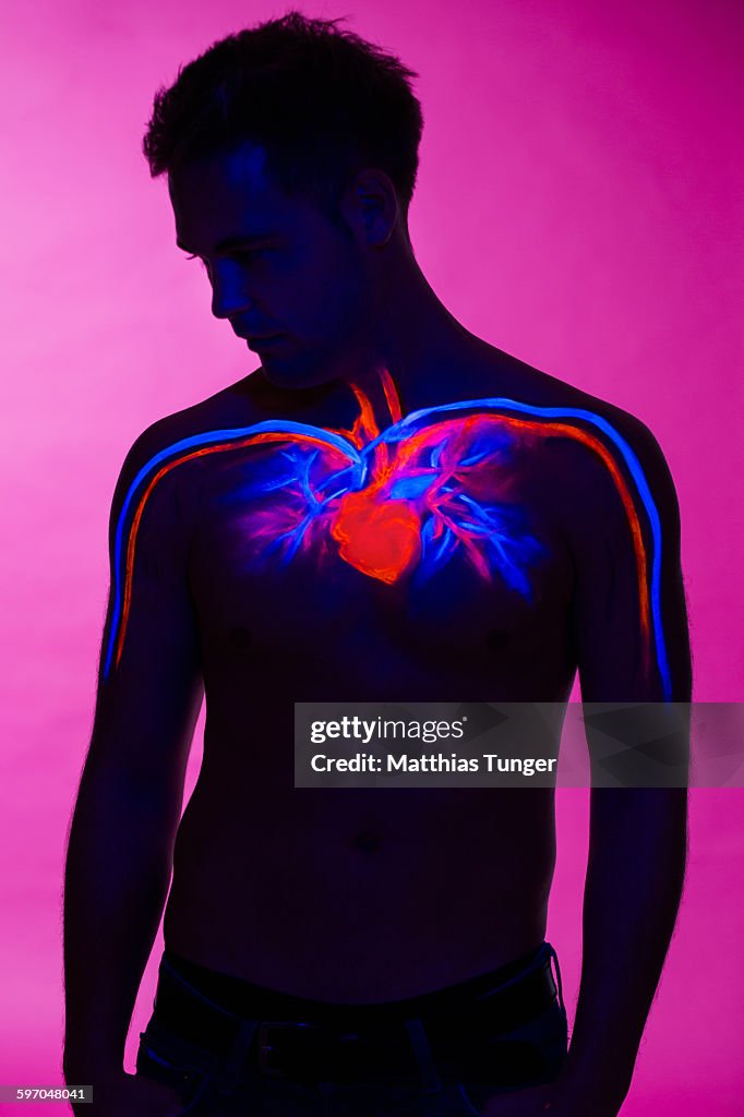 Heart painted on a torso of a man