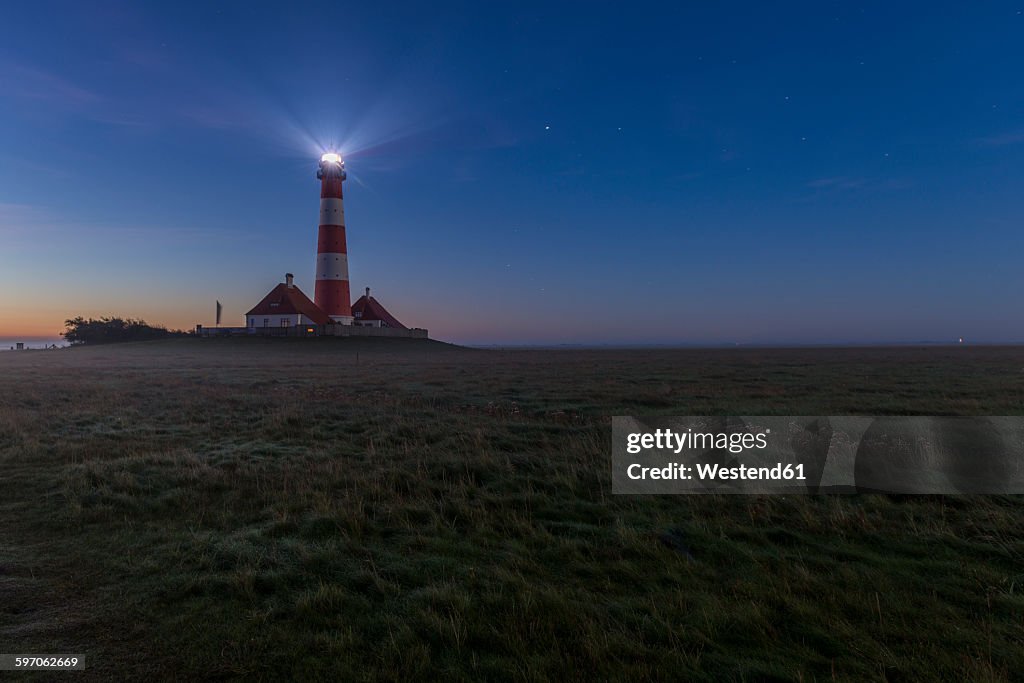 Germany, Schleswig-Holstein, North Sea Coast, View of Westerheversand Lighthouse at night