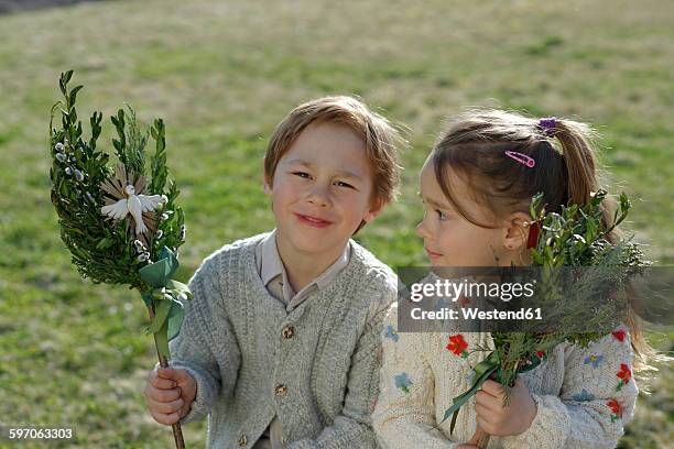 germany, upper bavaria, little boy and girl with palmbusch on a meadow - religious equipment stock pictures, royalty-free photos & images