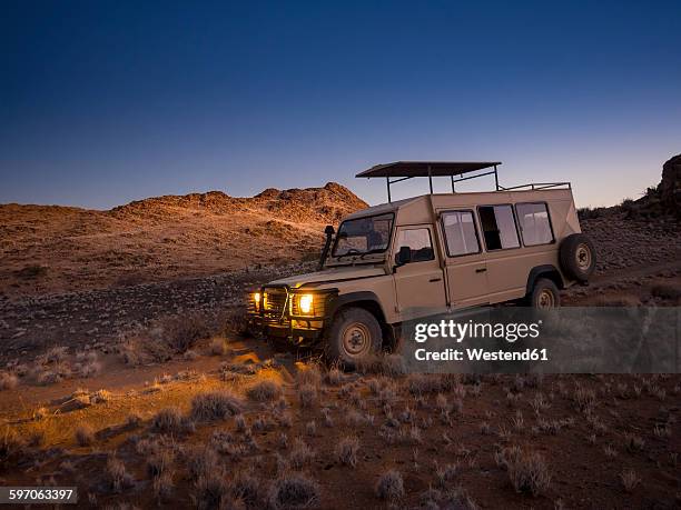 africa, namibia, namib desert, landrover in kulala wilderness reserve - jeep stock pictures, royalty-free photos & images