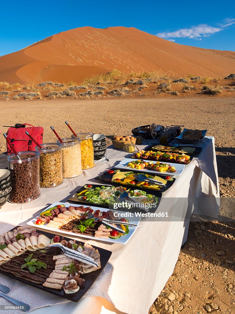 Namibia, Hardap, breakfast buffet on table in desert