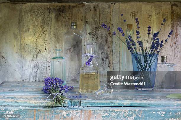 lavender oil in bottle - shabby chic stockfoto's en -beelden