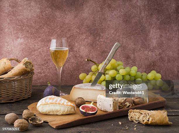 cheese platter with camembert, walnut cheese, gorgonzola, taleggio and champagne - cheese and champagne stock pictures, royalty-free photos & images