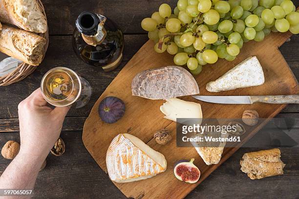 cheese platter with camembert, walnut cheese, gorgonzola, taleggio and champagne - cheese platter stock-fotos und bilder