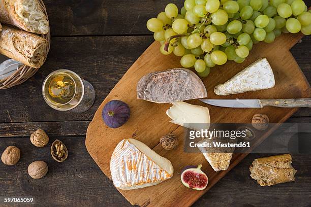 cheese platter with camembert, walnut cheese, gorgonzola, taleggio and champagne - cheese and champagne stock pictures, royalty-free photos & images