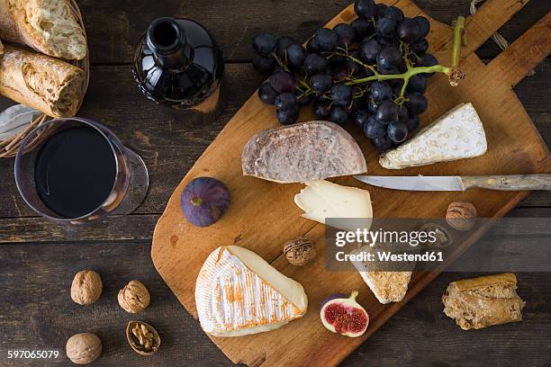 cheese platter with camembert, walnut cheese, gorgonzola and taleggio - cheese platter stock pictures, royalty-free photos & images