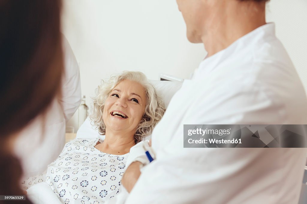 Senior woman in hospital talking to doctor