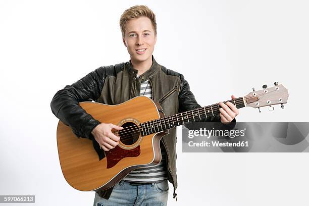 smiling young man playing guitar - guitarist bildbanksfoton och bilder