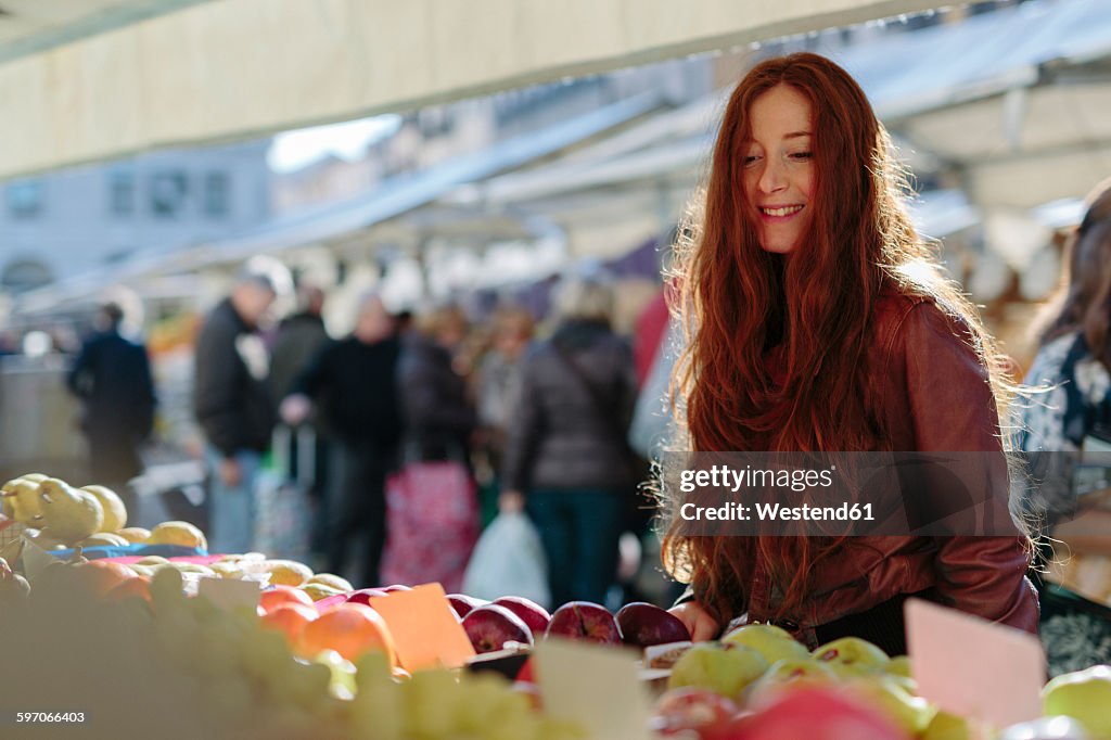 Smiling woman at fruit market