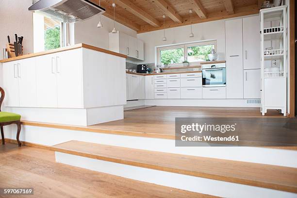 built-in kitchen with steps to living area - kitchen hardwood floor stock pictures, royalty-free photos & images