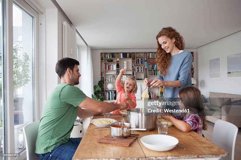 Couple with two children going to have lunch together at home