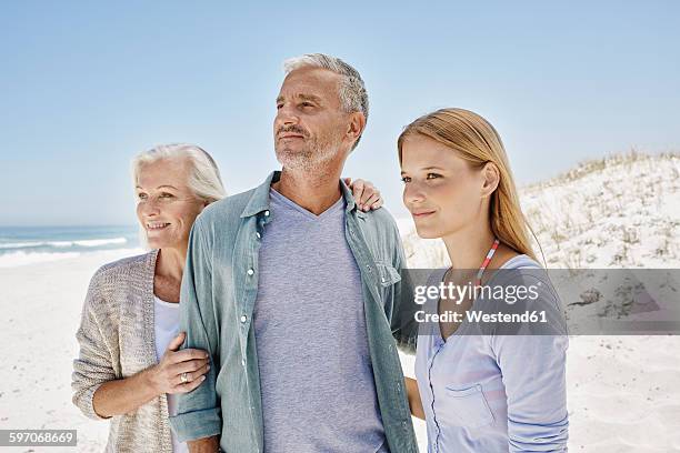 best ager with adult daughter at the beach - best ager woman stockfoto's en -beelden