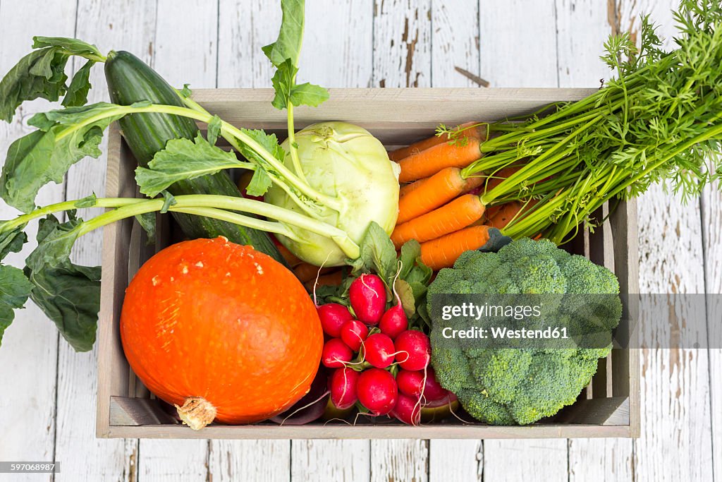 Wooden box of different vegetables