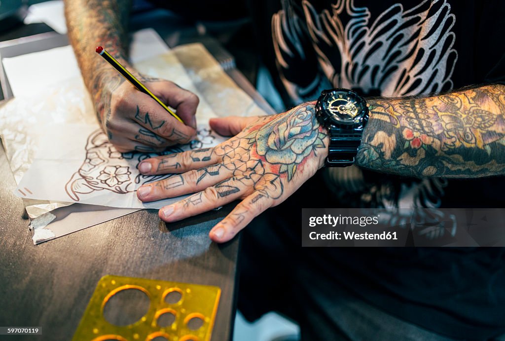 Tattoo artist designing motifs