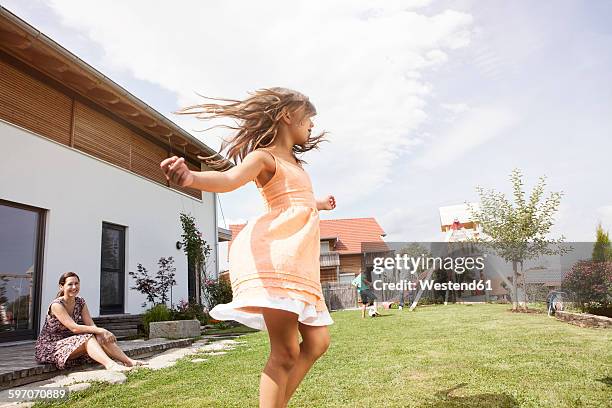 playful girl with family in garden - children dancing outside stock pictures, royalty-free photos & images