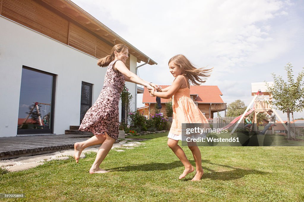 Carefree mother and daughter in garden