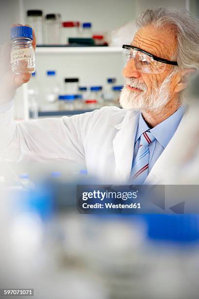 senior professor looking at laboratory glass - mad professor stock pictures, royalty-free photos & images