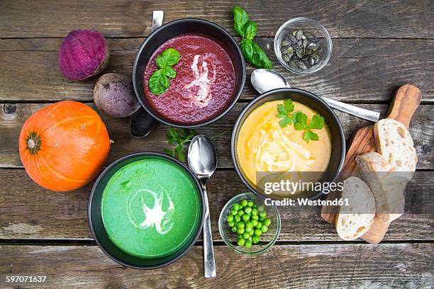 pea soup, beetroot and pumpkin soup in bowls - green pea soup stock pictures, royalty-free photos & images