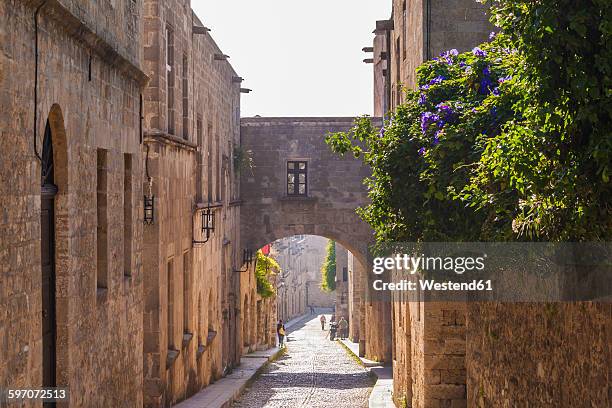 greece, rhodes, old town, medieval road odos ippoton - greek arch stock-fotos und bilder