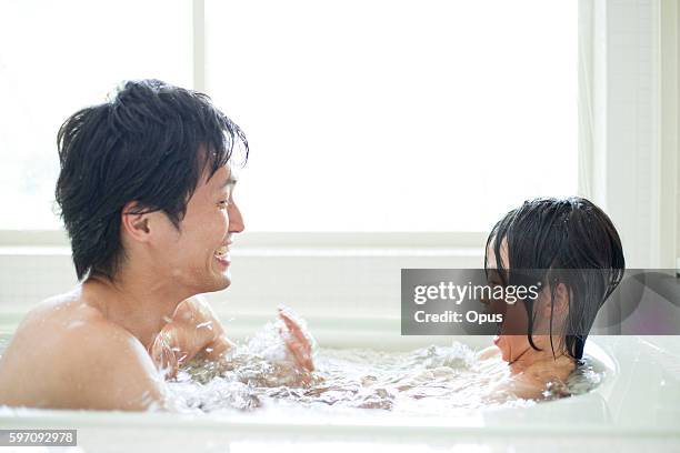 father and son taking a bath, hyogo prefecture, honshu, japan - taking a bath stock-fotos und bilder