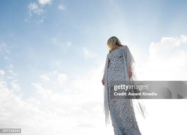 haute couture model looks off into lofty sky - haute couture stockfoto's en -beelden