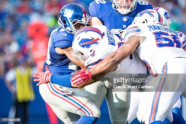 Jerel Worthy of the Buffalo Bills tackles Andre Williams of the New York Giants during the second half on August 20, 2016 at New Era Field in Orchard...